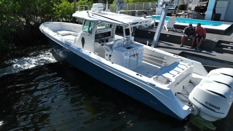 Slide: The Image of 2008 Everglades 350 CC boat docked near a pool, featuring Yamaha engines. - 6
