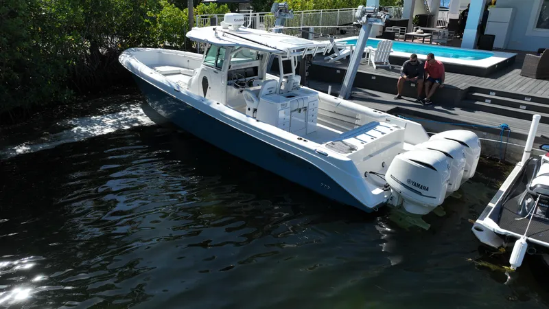 Slide: The Image of 2008 Everglades 350 CC boat docked near a poolside area. - 8