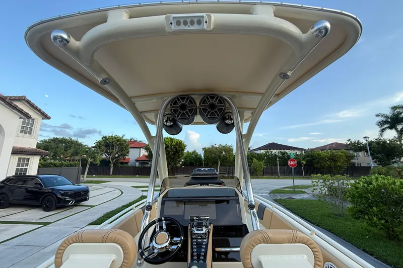 Slide: The Image of 2014 Custom Latitude Powerboats 28 CC with modern helm, parked in a residential driveway. - 15