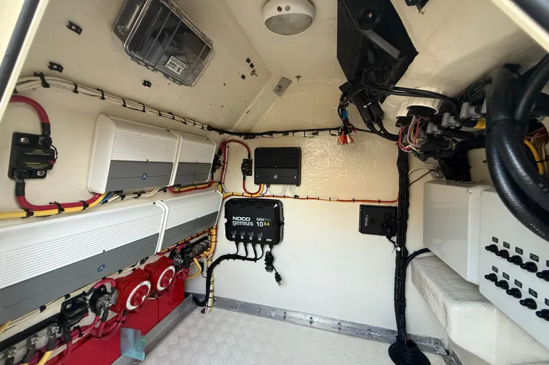 Slide: The Image of Electrical system inside a 2014 Custom Latitude Powerboats 28 CC, featuring wiring and control panels. - 24