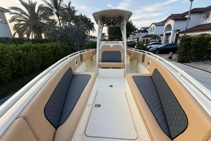 Slide: The Image of 2014 Custom Latitude Powerboats 28 CC with spacious seating and elegant design in a residential setting. - 39