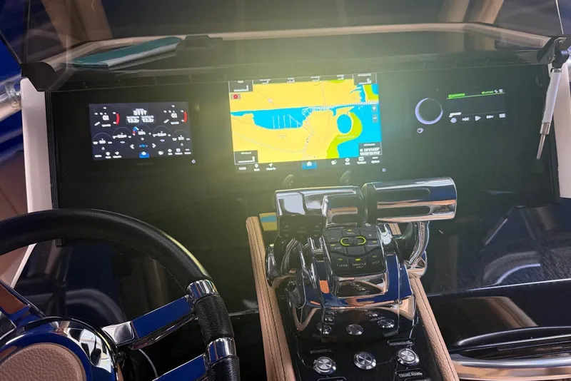 Slide: The Image of Dashboard of a 2014 Latitude 28 CC boat with navigation and control systems. - 12