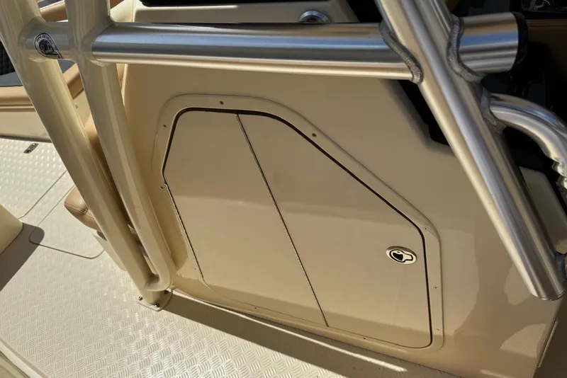 Slide: The Image of 2014 Latitude 28 CC boat console with beige panel and stainless steel railings. - 18