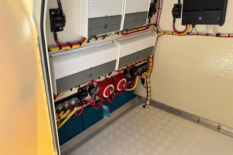 Slide: The Image of Electrical system inside a 2014 Latitude 28 CC boat, featuring organized wiring and components. - 19