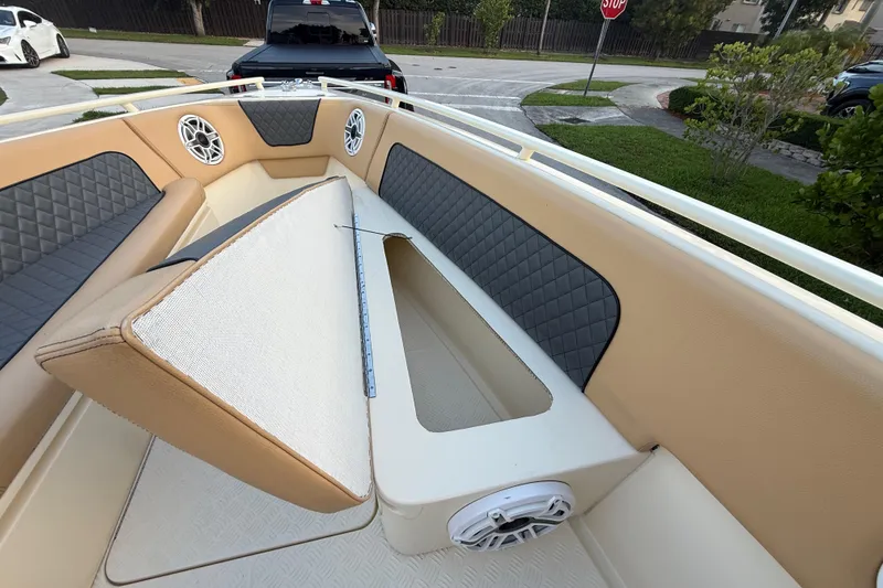 Slide: The Image of 2014 Custom Latitude Powerboats 28 CC interior with cushioned seating and storage compartment. - 36
