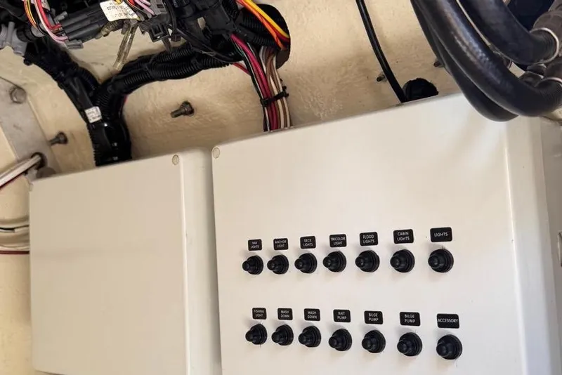 Slide: The Image of Control panel with labeled switches on a 2014 Latitude 28 CC boat. - 20