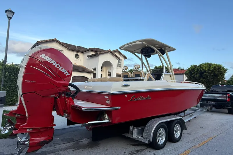 Slide: The Image of Red 2014 Latitude 46 28 CC boat with Mercury Verado engine on trailer, residential background. - 23