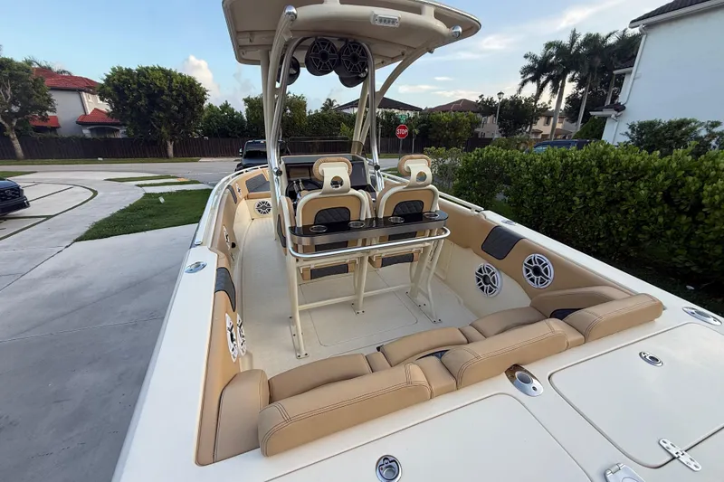 Slide: The Image of 2014 Latitude 46 28 CC boat interior with beige seating and modern amenities. - 26