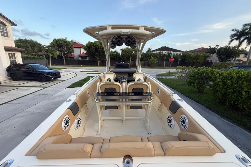 Slide: The Image of 2014 Latitude 46 28 CC boat with beige seating and modern audio system in a driveway. - 27