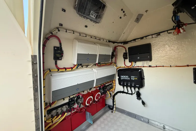 Slide: The Image of Electrical system inside a 2014 Custom Latitude Powerboats 28 CC, featuring NOCO Genius GenPro 10x4 charger. - 25