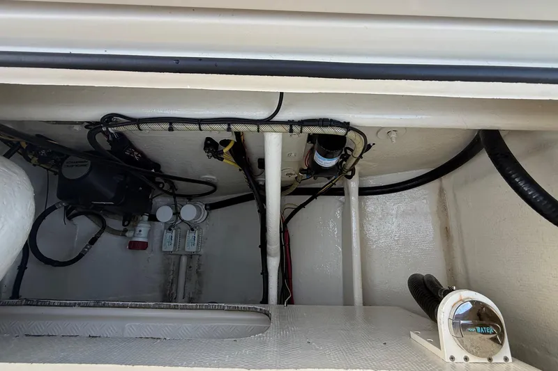 Slide: The Image of 2014 Custom Latitude Powerboats 28 CC engine compartment with wiring and components. - 11