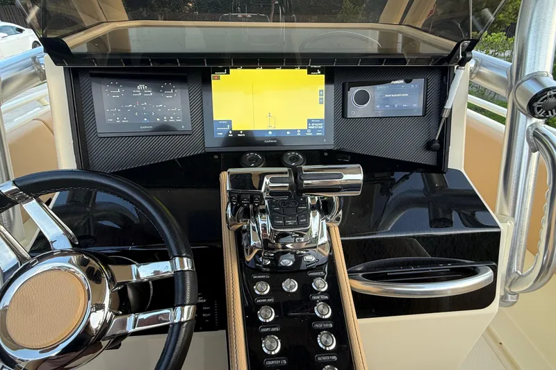 Slide: The Image of Dashboard of 2014 Custom Latitude Powerboats 28 CC with navigation and control systems. - 18