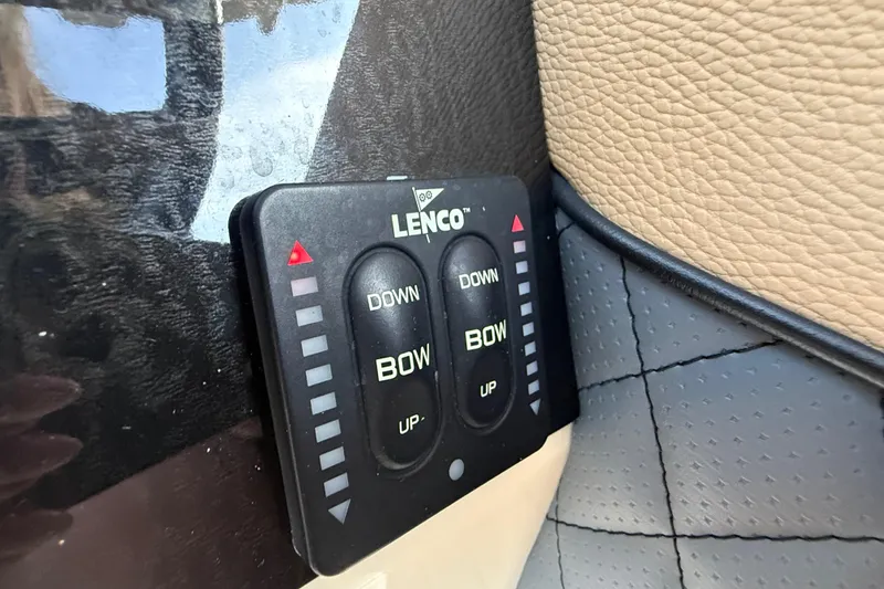 Slide: The Image of Lenco trim tab control on 2014 Latitude Powerboats 28 CC dashboard. - 19