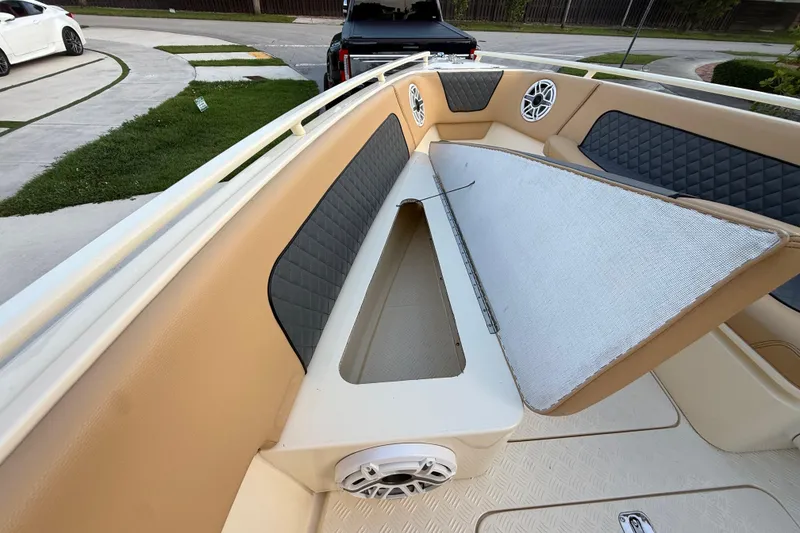 Slide: The Image of 2014 Custom Latitude Powerboats 28 CC interior with open storage compartment and speakers. - 35