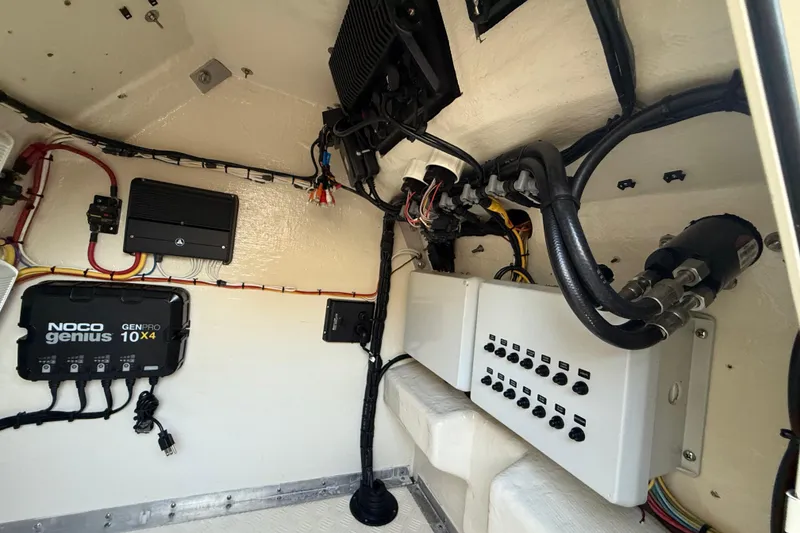 Slide: The Image of Electrical system inside 2014 Custom Latitude Powerboats 28 CC, featuring Noco Genius GenPro 10x4 charger. - 26