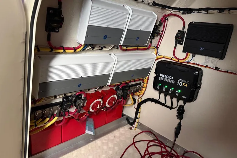 Slide: The Image of Electrical system setup in a 2014 Latitude 28 CC boat, featuring NOCO Genius charger. - 13