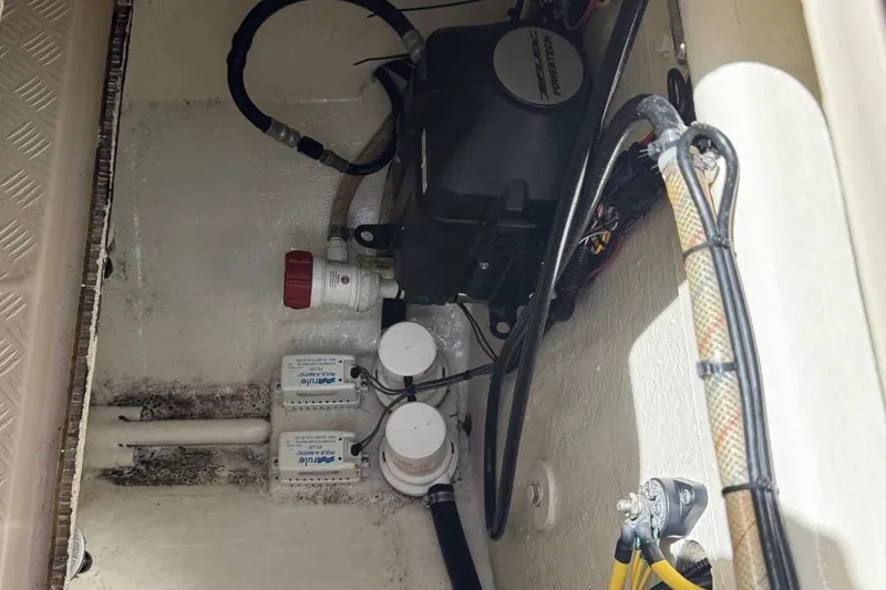 Slide: The Image of 2014 Latitude 28 CC boat interior wiring and pump system. - 16