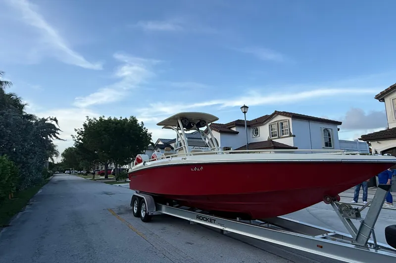 Slide: The Image of Red 2014 Latitude 46 28 CC boat on trailer in suburban neighborhood. - 24