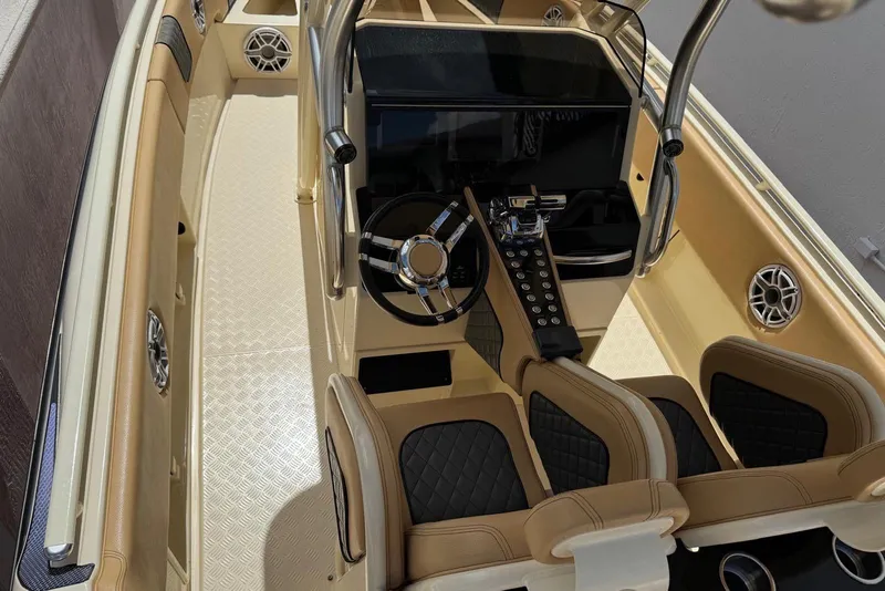 Slide: The Image of Interior view of a 2014 Latitude 28 CC boat, featuring a sleek helm and seating. - 6
