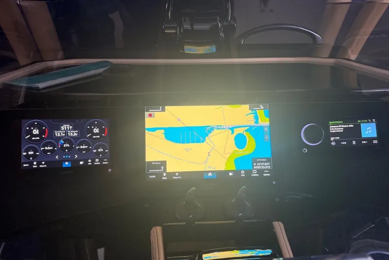 Slide: The Image of Dashboard of a 2014 Latitude 28 CC boat with navigation and control displays. - 8