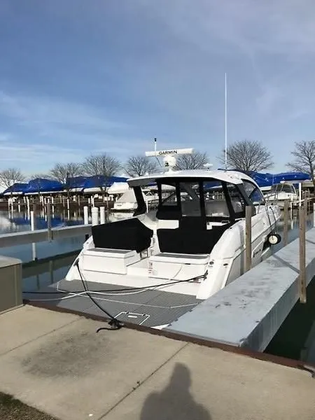 Slide: The Image of A 2018 Cruisers Yachts 39 Express Coupe docked. It features a sleek, modern design. - 6