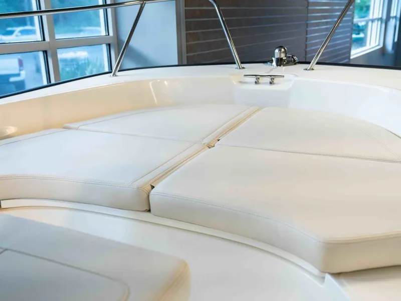 Slide: The Image of The image shows the bow area of a Boston Whaler 170 Montauk with white cushions. - 9
