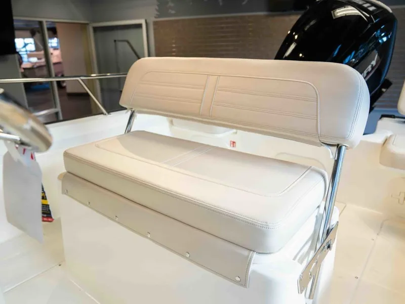 Slide: The Image of The 2026 Boston Whaler 170 Montauk features a cushioned bench seat with a stainless steel frame. - 13