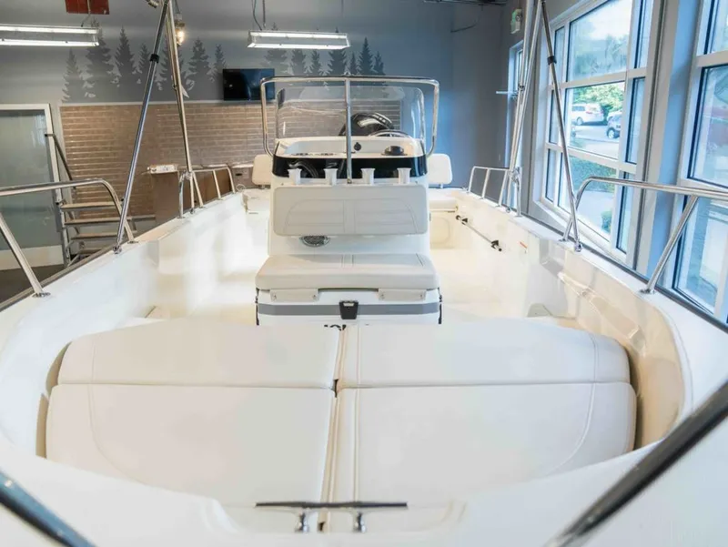 Slide: The Image of The image shows the interior of a Boston Whaler 170 Montauk boat with white seating and helm console. - 10