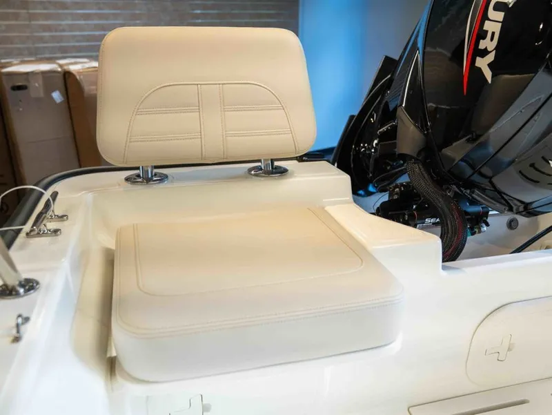 Slide: The Image of The image shows a seating area of a Boston Whaler 170 Montauk boat with a Mercury engine. - 4