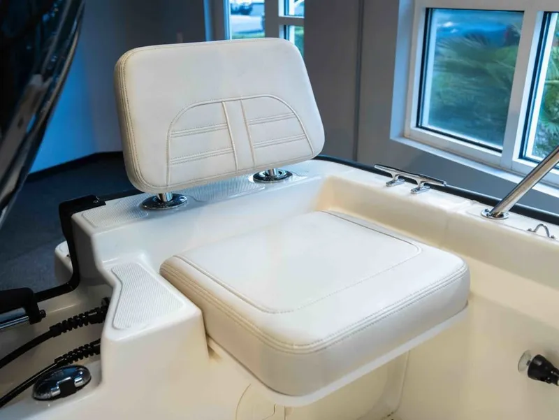 Slide: The Image of A white seat on a boat with windows in the background. - 6