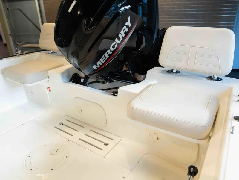 Slide: The Image of The image shows the interior of a Boston Whaler 170 Montauk with a Mercury engine. - 14