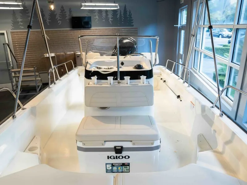 Slide: The Image of The image shows a 2026 Boston Whaler 170 Montauk boat in a showroom. - 11