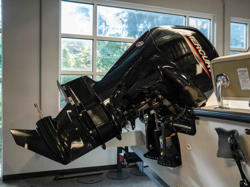 Slide: The Image of A Mercury outboard motor is mounted on a Boston Whaler 170 Montauk boat in a showroom. - 15