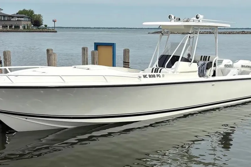 The Image of 1994 Intrepid 30 Open Cuddy boat docked by the waterfront. - 0