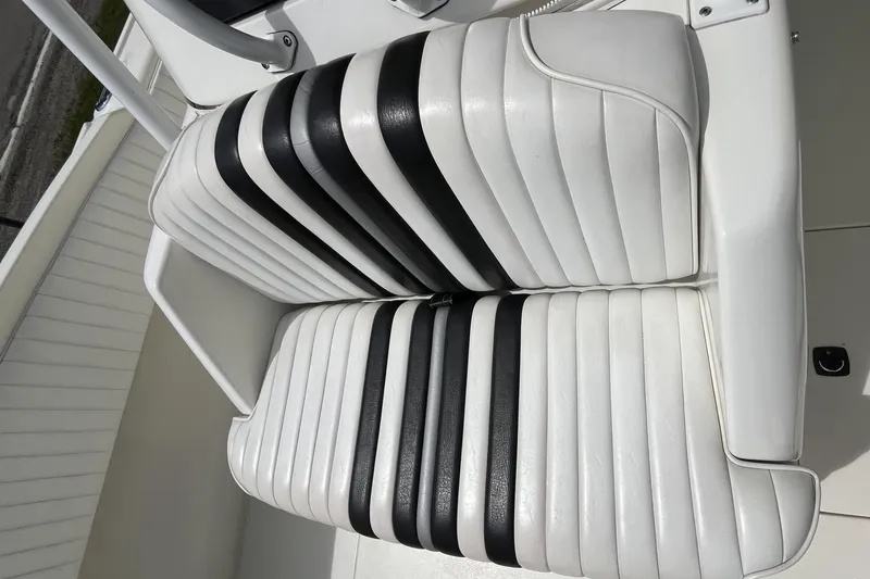 Slide: The Image of White and black striped seating on a 1994 Intrepid 30 Open Cuddy boat. - 12