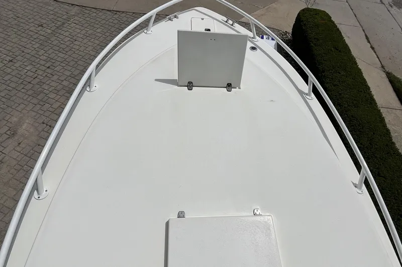 Slide: The Image of Bow view of a 1994 Intrepid 30 Open Cuddy boat, featuring a clean white deck. - 15