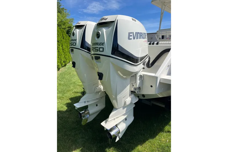 Slide: The Image of Twin Evinrude 250 outboard engines on a 1994 Intrepid 30 Open Cuddy boat. - 18