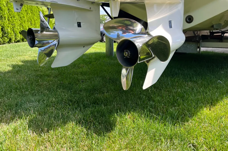 Slide: The Image of Propellers of a 1994 Intrepid 30 Open Cuddy boat on grass. - 19