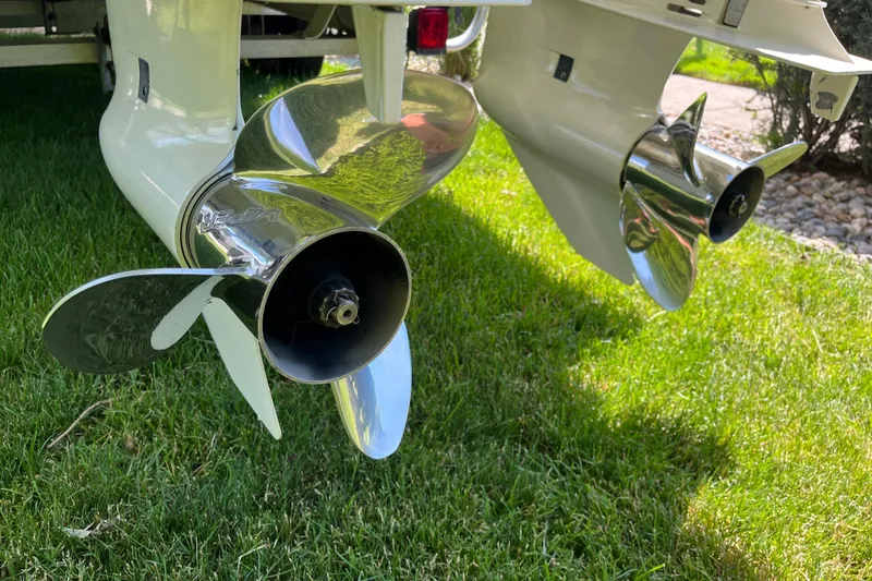 Slide: The Image of Propellers of a 1994 Intrepid 30 Open Cuddy boat on grass. - 20