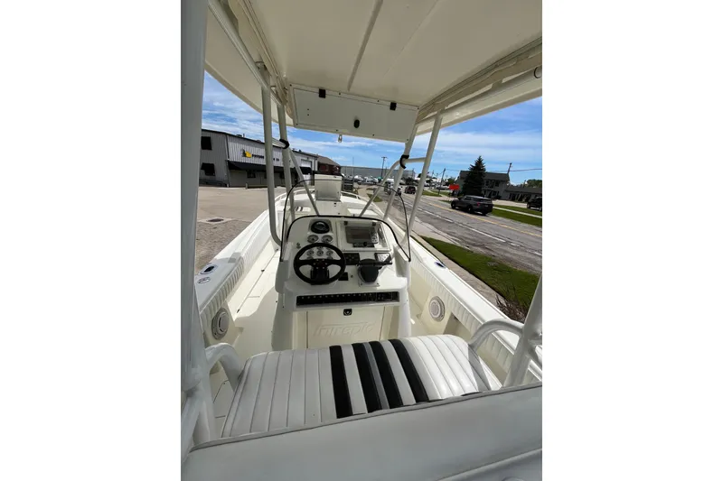 Slide: The Image of 1994 Intrepid 30 Open Cuddy boat interior with steering wheel and seating. - 7