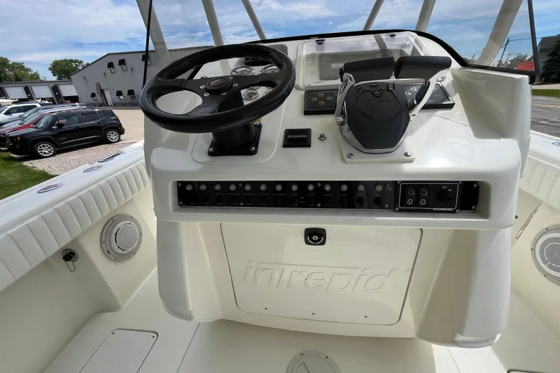 Slide: The Image of 1994 Intrepid 30 Open Cuddy boat helm with steering wheel and control panel. - 9