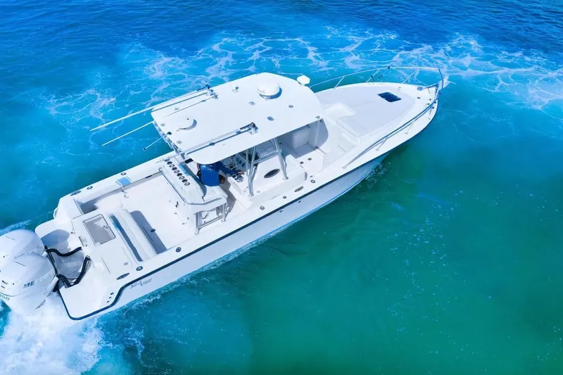 The Image of 2009 SeaVee 340B Cuddy cruising on vibrant blue ocean waters. - 0