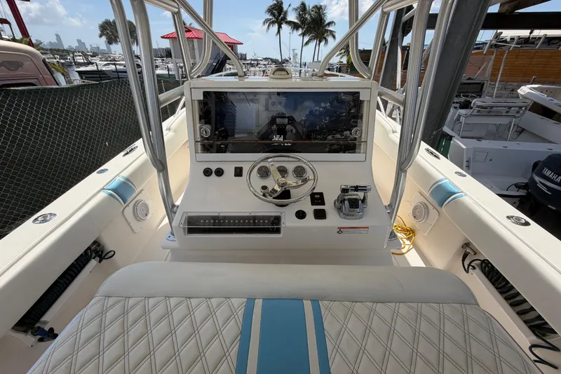 Slide: The Image of 2009 SeaVee 340B Cuddy boat dashboard with steering wheel and controls. - 10