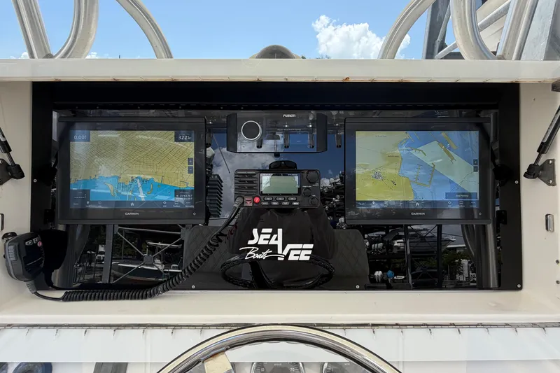Slide: The Image of 2009 SeaVee 340B Cuddy dashboard with dual Garmin navigation screens and communication equipment. - 12
