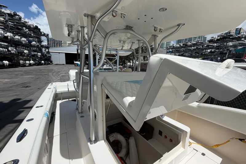 Slide: The Image of 2009 SeaVee 340B Cuddy boat interior with open storage compartment, docked at marina. - 13
