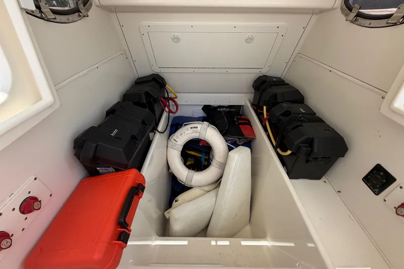 Slide: The Image of Interior of 2009 SeaVee 340B Cuddy boat with storage compartments and safety equipment. - 15
