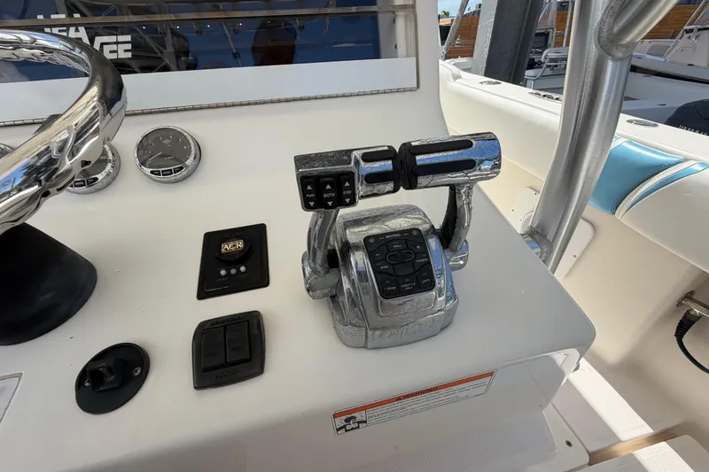 Slide: The Image of 2009 SeaVee 340B Cuddy helm controls with steering wheel and throttle levers. - 20