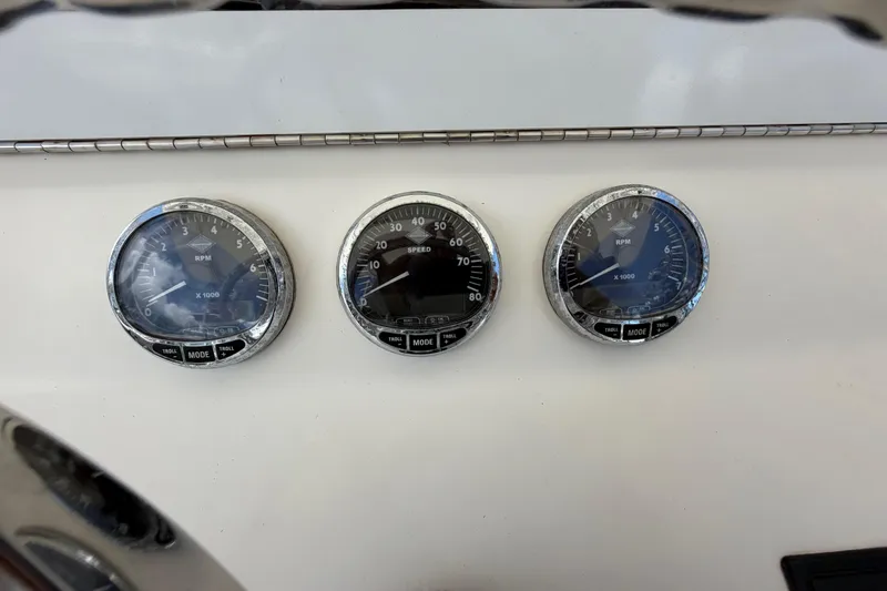 Slide: The Image of Dashboard gauges of a 2009 SeaVee 340B Cuddy boat, displaying RPM and speed. - 22