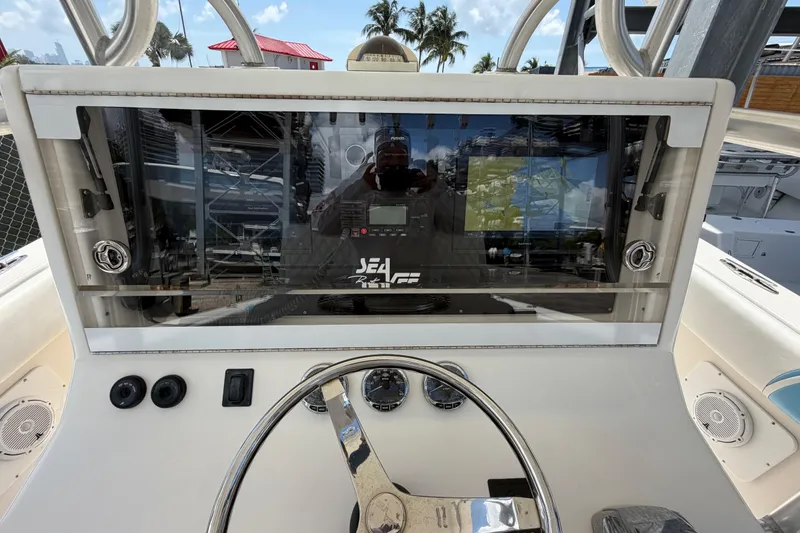 Slide: The Image of 2009 SeaVee 340B Cuddy helm with modern navigation equipment and steering wheel. - 23