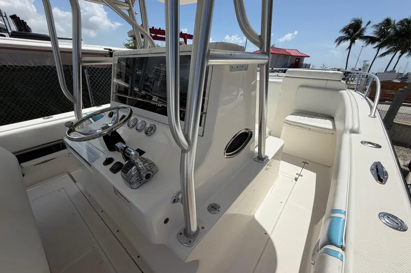 Slide: The Image of 2009 SeaVee 340B Cuddy boat cockpit with steering wheel and controls, under clear sky. - 25